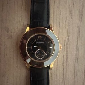 Black Swarovski watch with gold and leather extensible